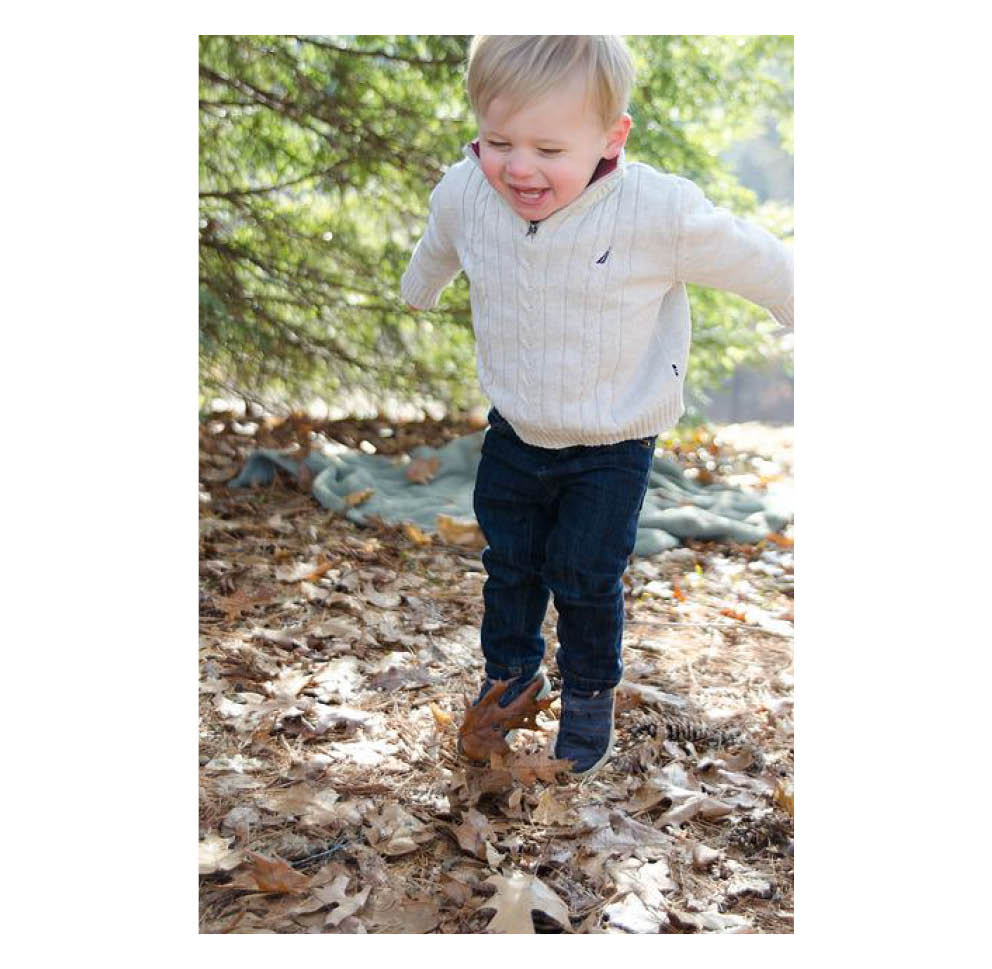 Child jumping in the woods