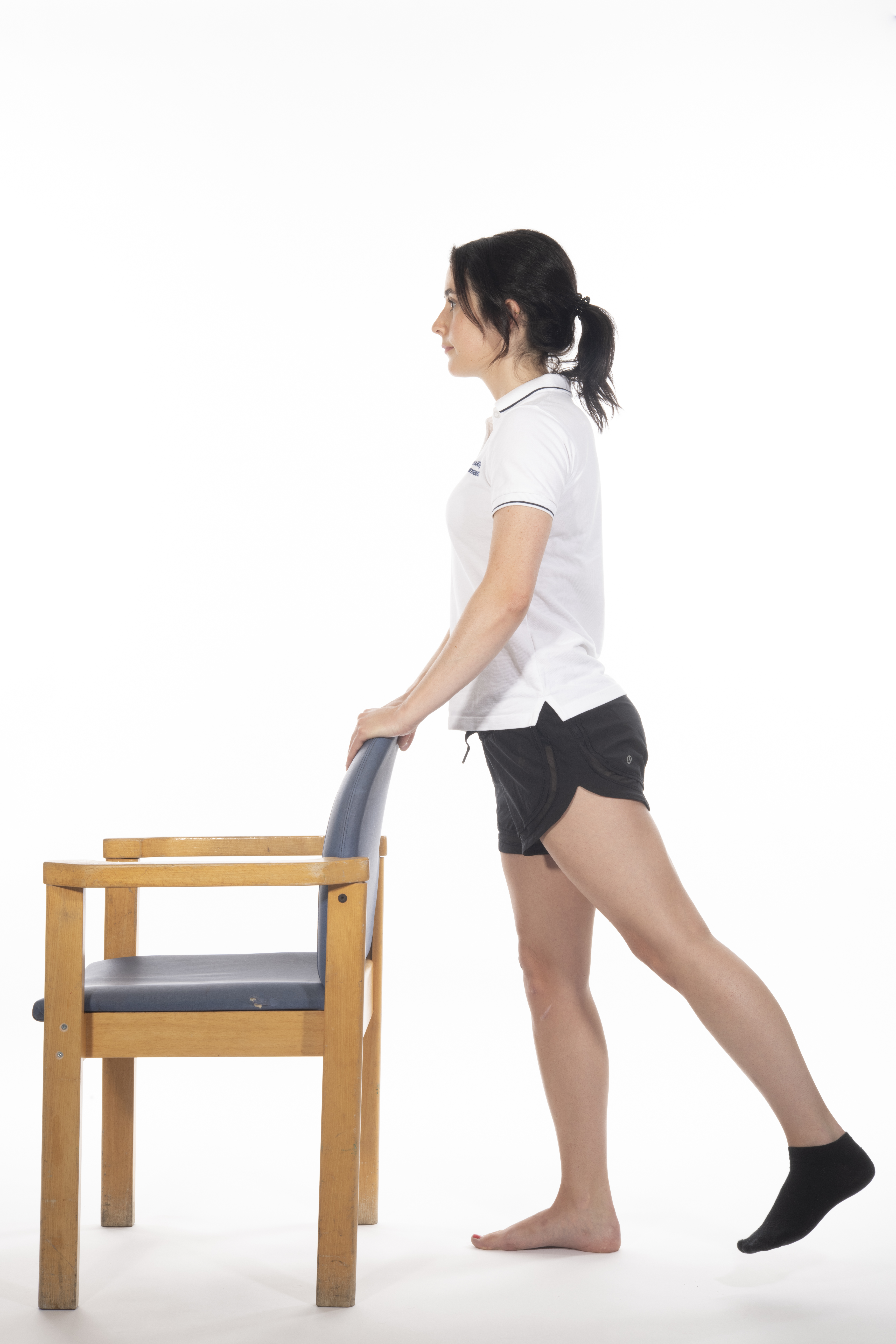 Hip extension in standing exercise; lift your operated leg backwards, clenching your bottom muscles while keeping your knee straight