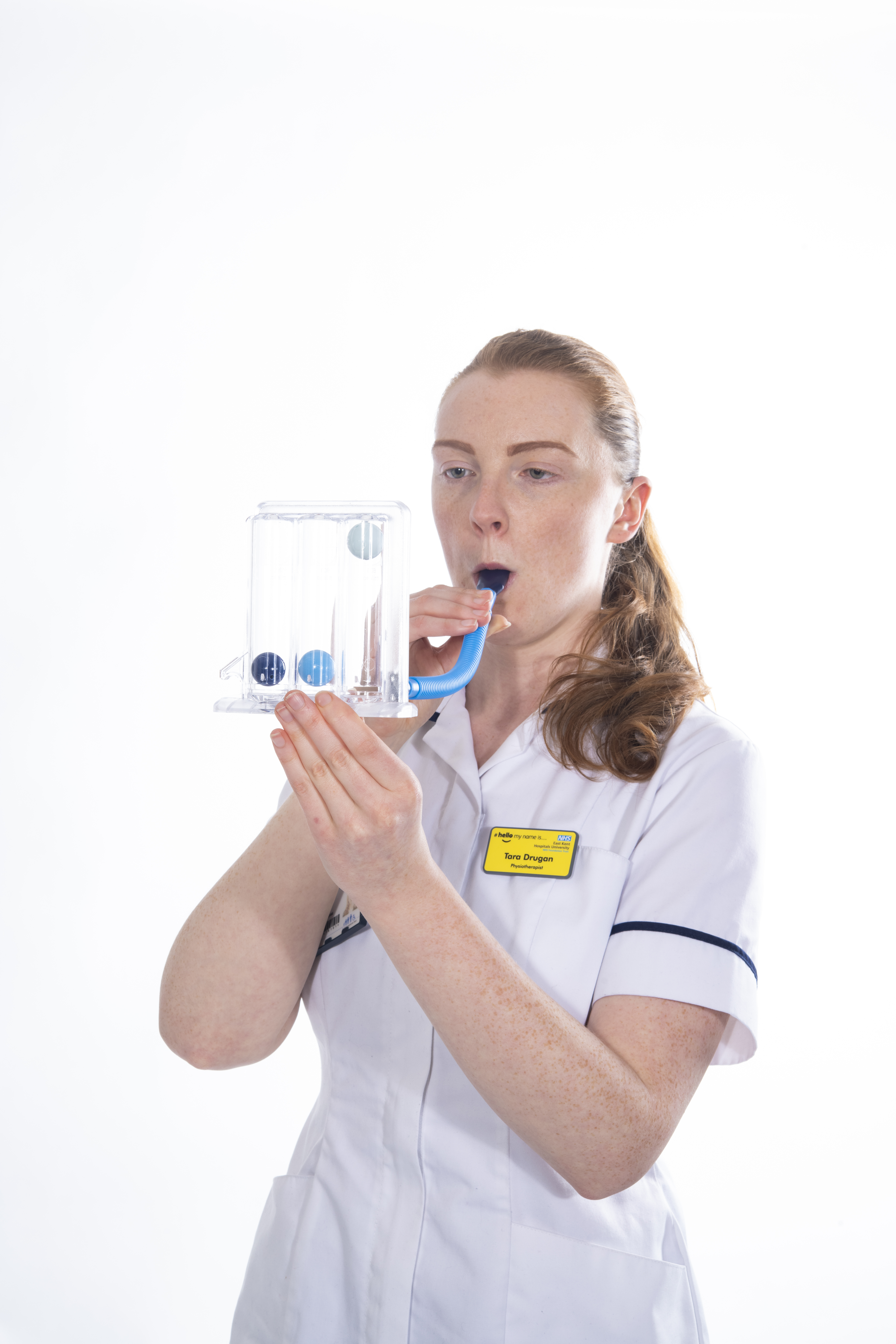 Blow into the incentive spirometer and make one ball rise
