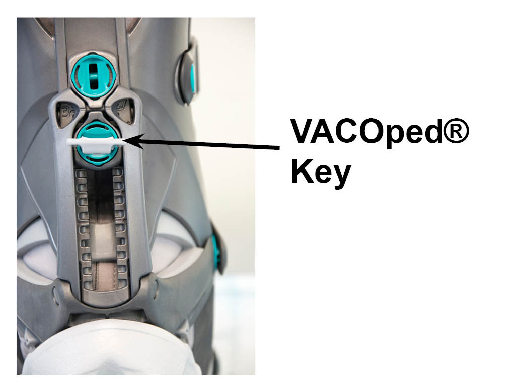Insert the VACOped® Key in the lower “keyhole”
