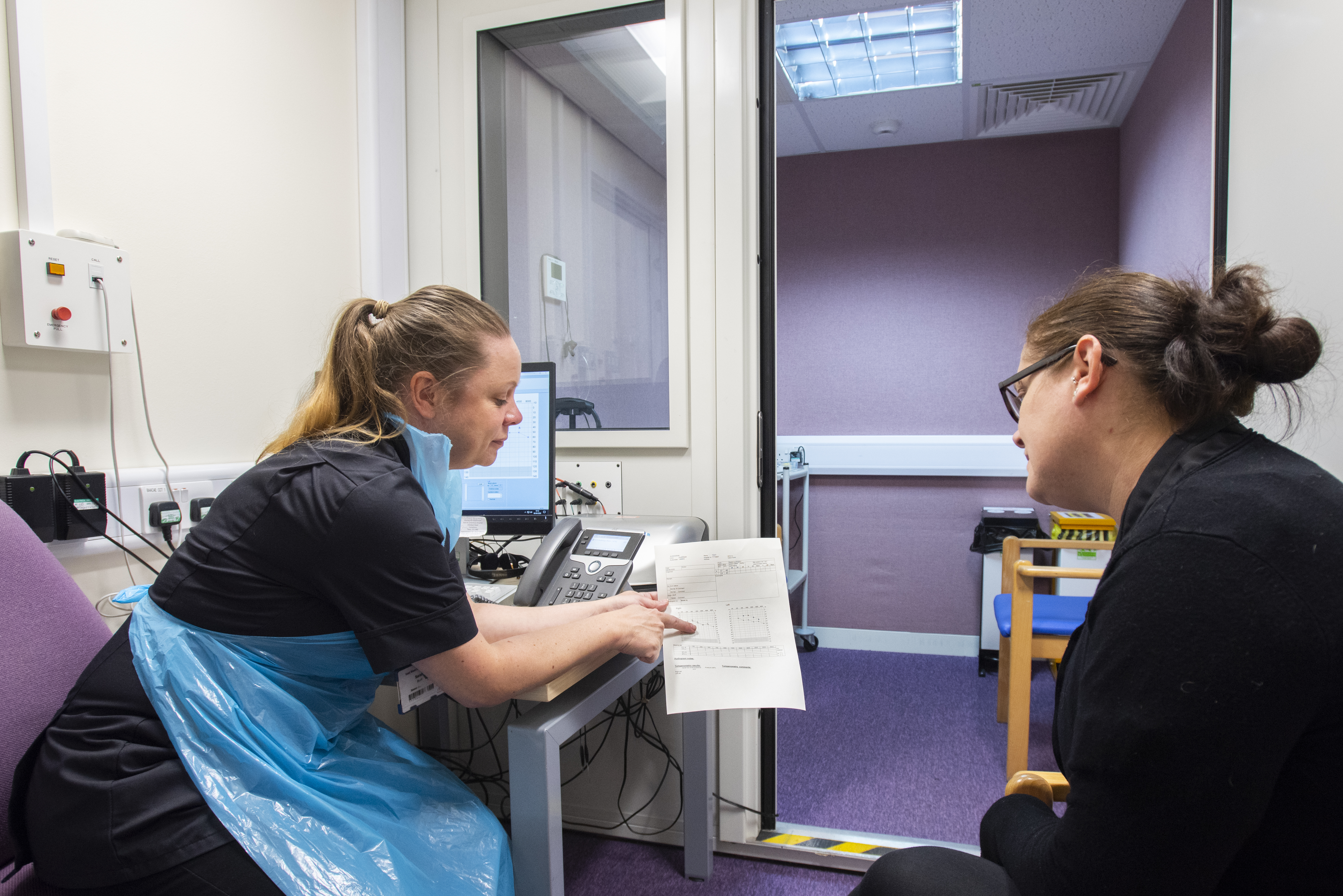 Audiologist showing the patient their results on a piece of paper