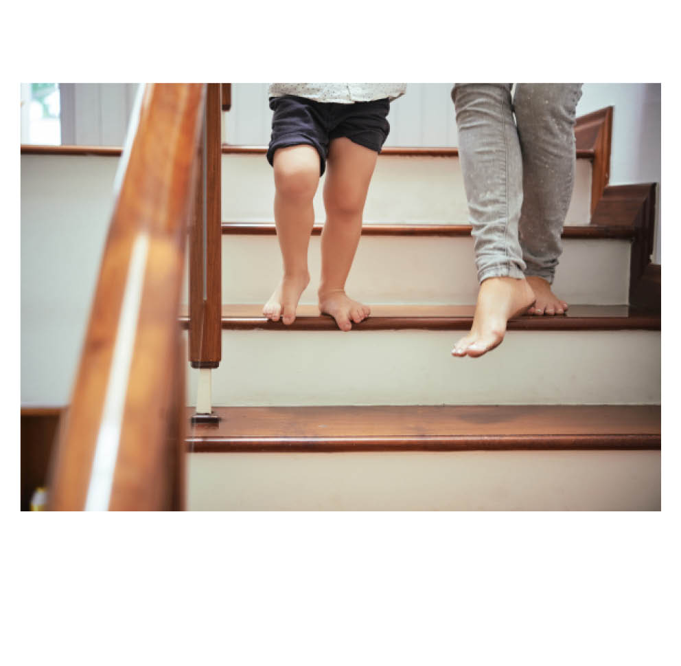 Adult and child walking down stairs